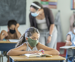 Children in classroom wearing masks