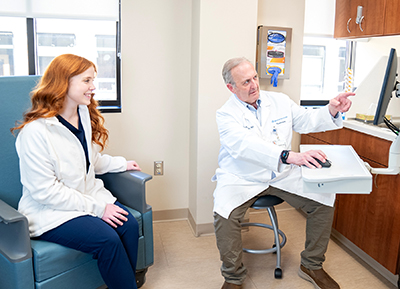 Neurosurgeon John Campbell reviewing results with a patient in the office