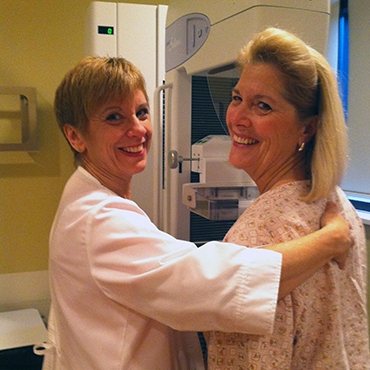 Woman and healthcare provider with mammography machine