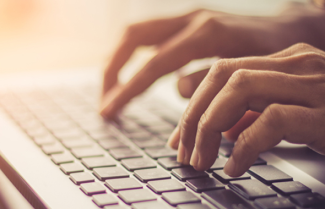 Fingers typing on keyboard