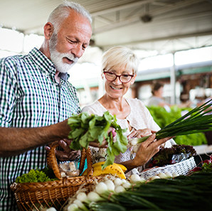 Older couple shopping for produce