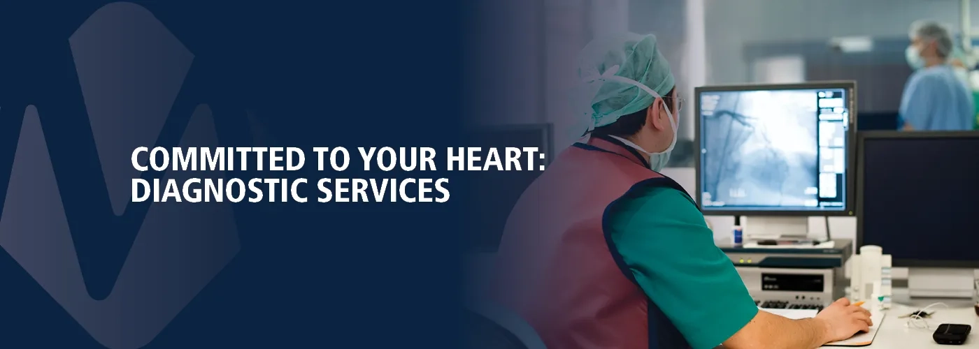 Healthcare provider looking at imaging on a computer monitor. Committed to Your Heart.