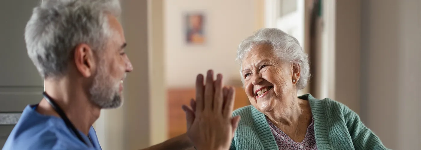 Staff member giving resident a high five